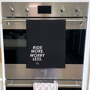Ride More. Worry Less. Tea Towel